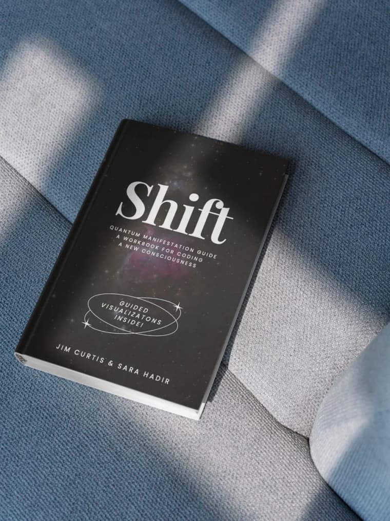 The Shift Workbook by Jim Curtis and Sara Hadir, resting on blue linen
